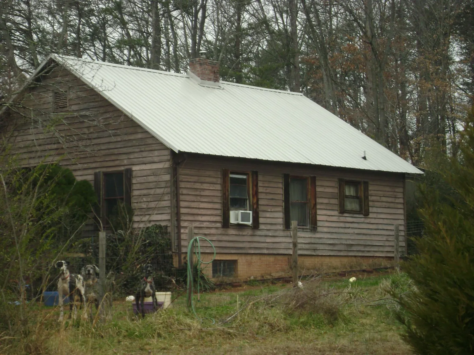 White metal roof on an old wood sided farmhouse, from a Asphalt Shingle Roof Repair job in Lewisburg